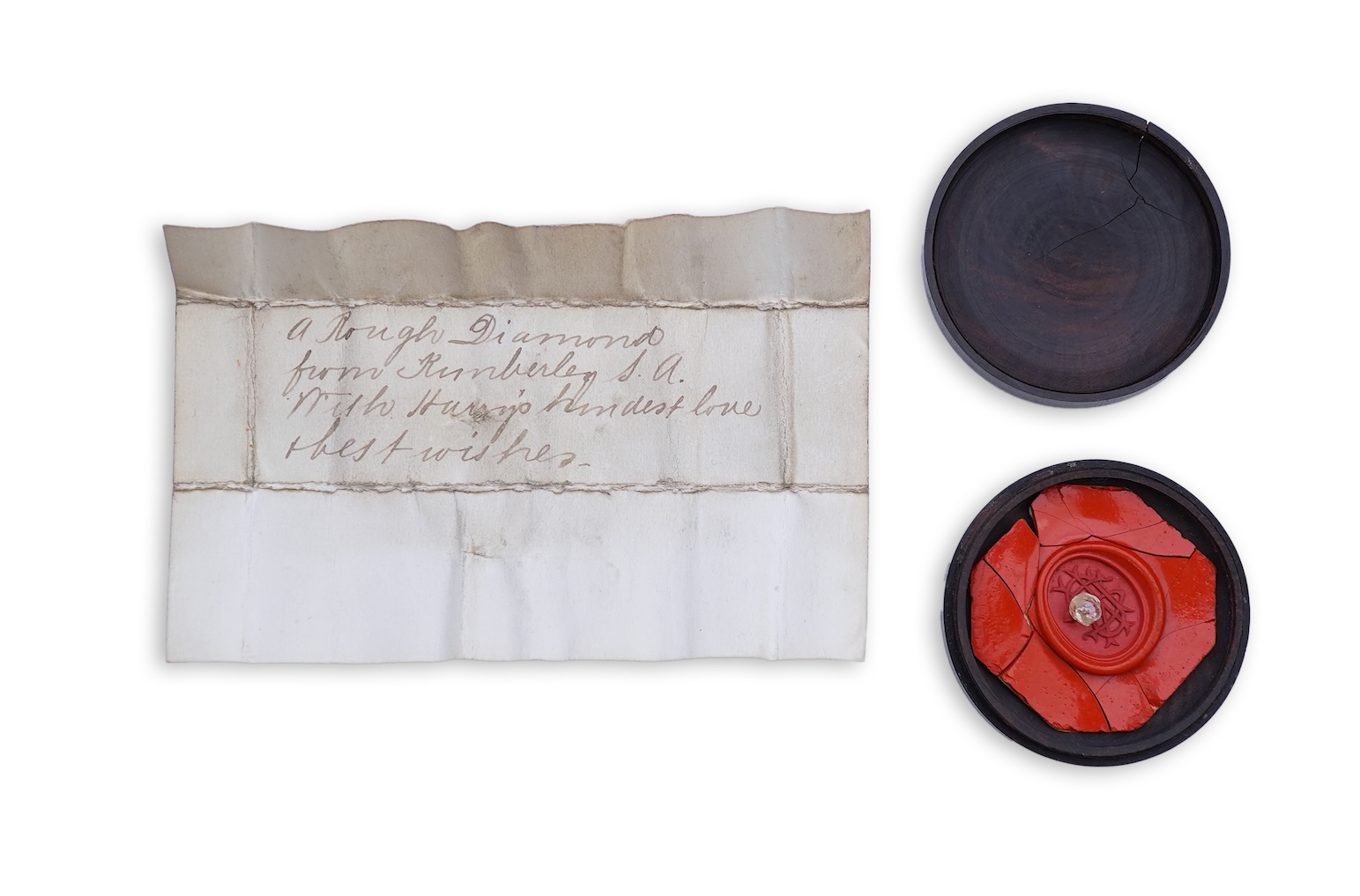 A rough diamond, with accompanying box and note, late 19th century
